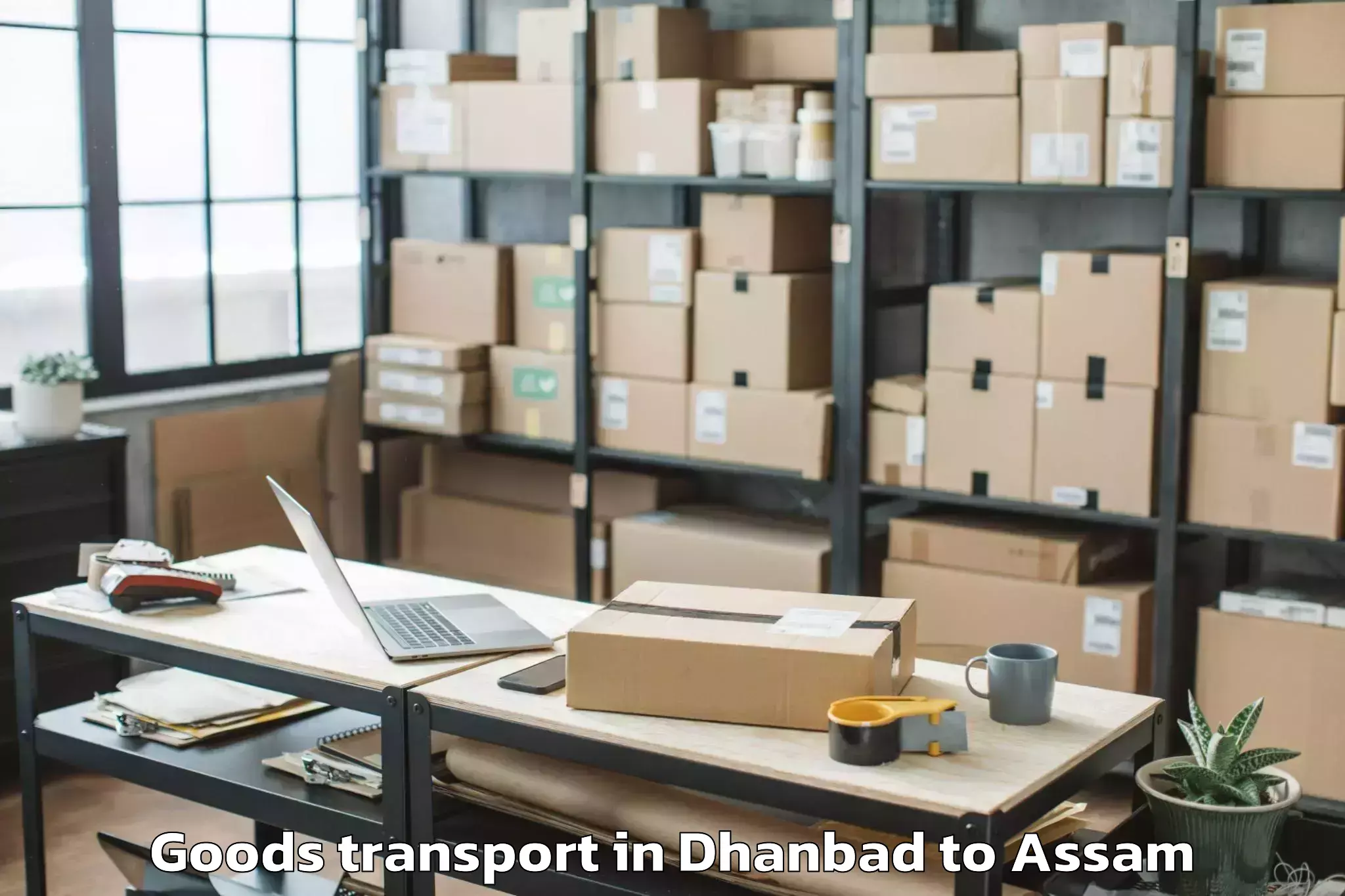 Easy Dhanbad to Borjhar Airport Gau Goods Transport Booking